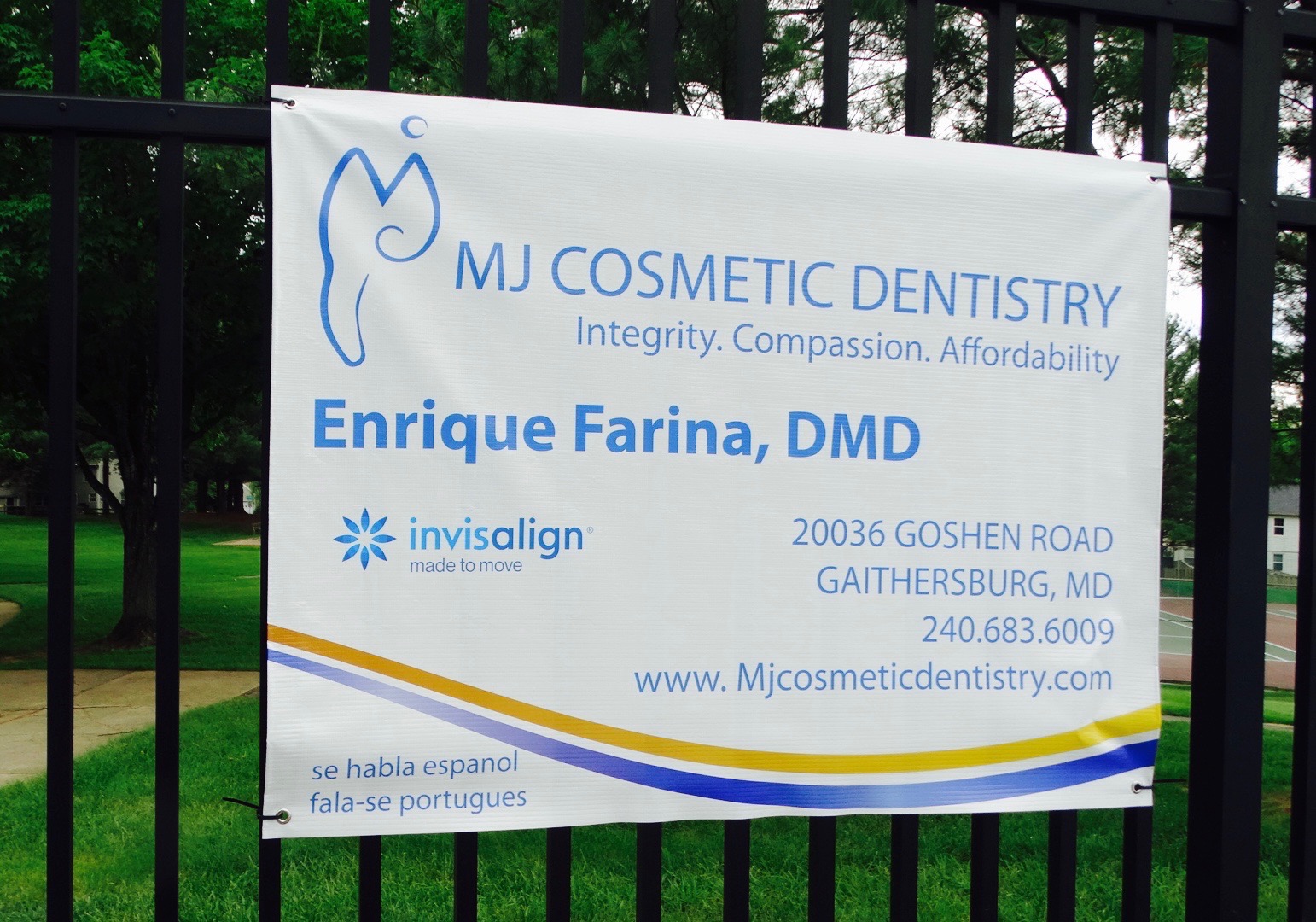 sign for MJ Cosmetic Dentistry on black gate